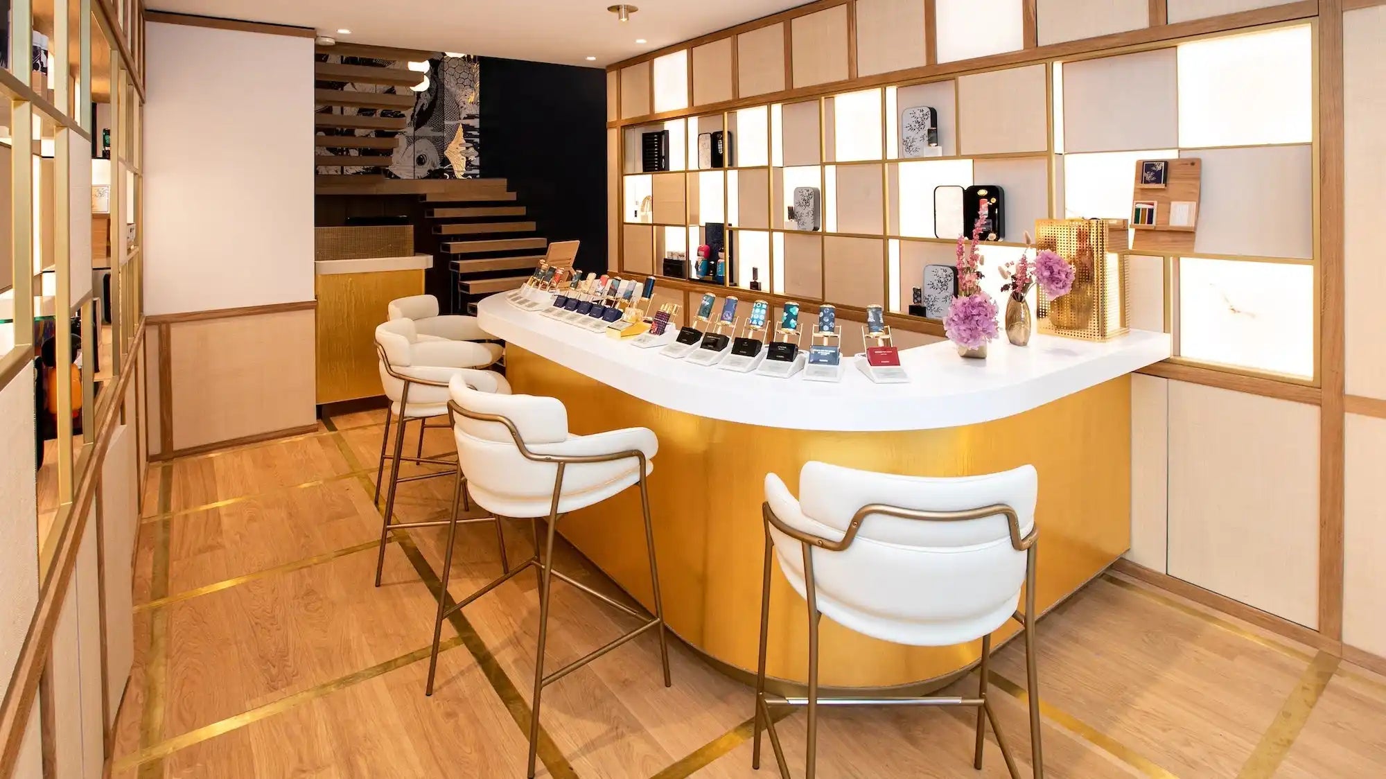 Curved wooden bar counter with white top and modern bar stools.