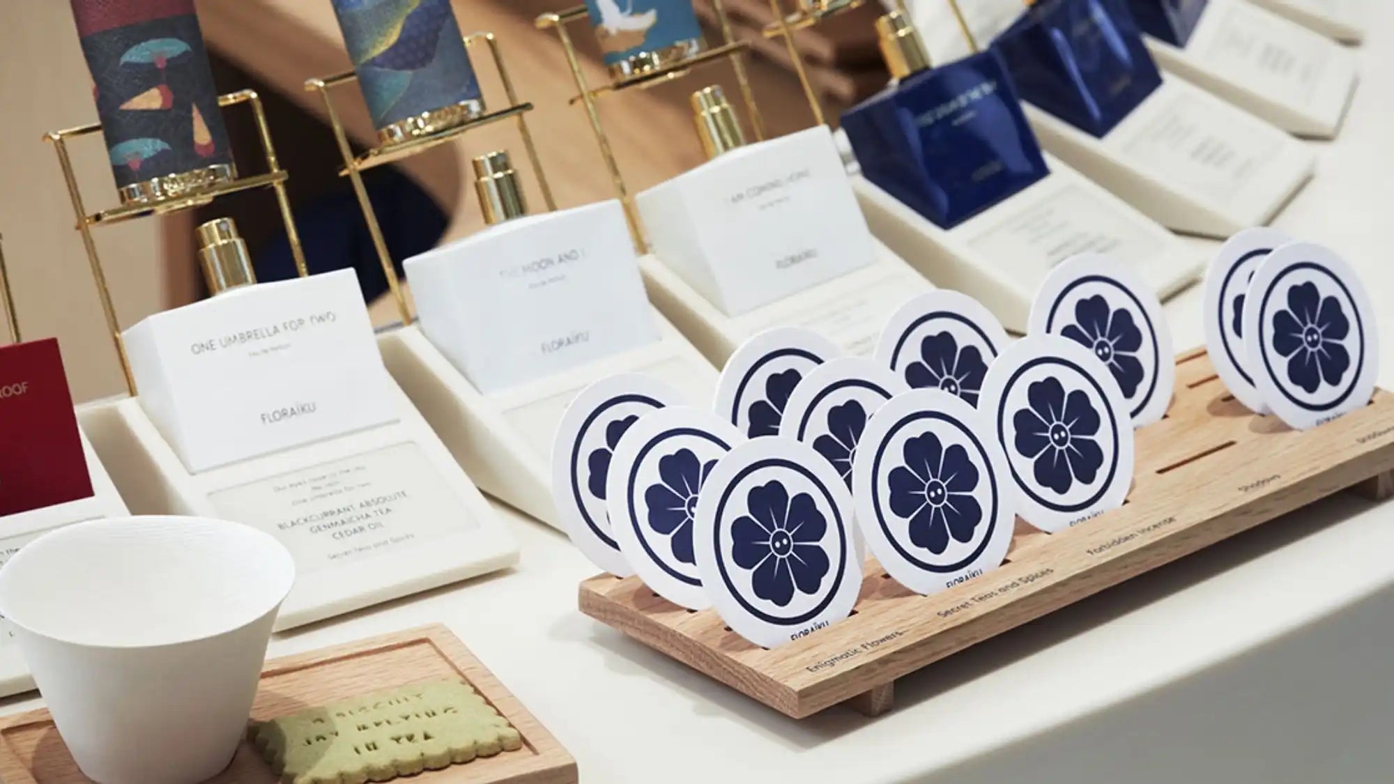 Row of circular blue and white floral coasters displayed on a wooden holder.